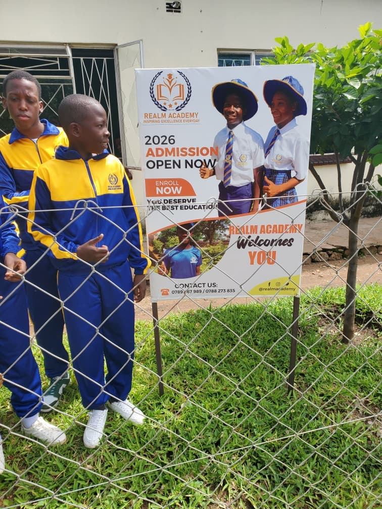 Realm students beside an admissions information display