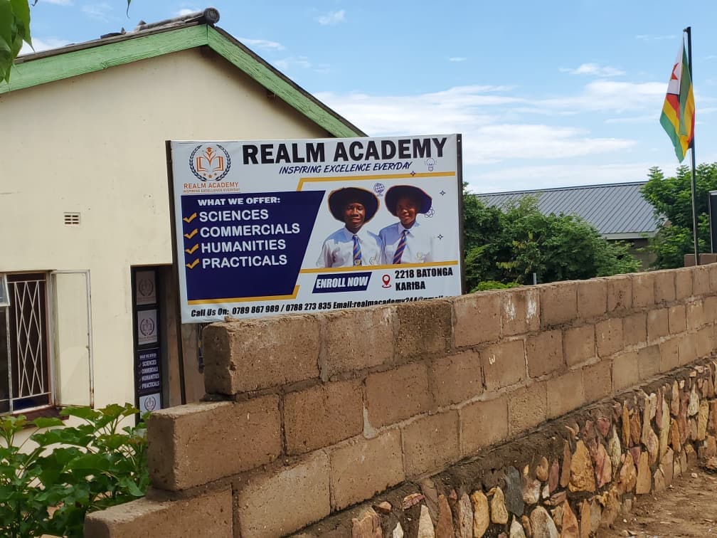 Realm campus exterior and school information sign