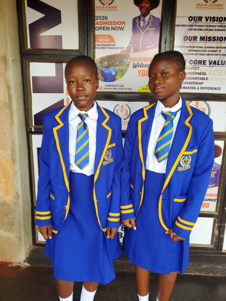 Two Realm students in blue and gold school uniform